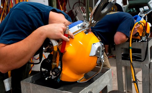 US Navy 110426-N-OT964-090 Navy Divers 2nd Class Troy Crowder, left, and Cody Creger test the voice communications inside of Kirby Morgan 37 diving