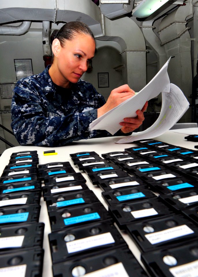 US Navy 110425-N-DM338-059 Hopsital Corpsman 1st Class Angela Kennedy, from Wendover, Utah, screens the names of Sailors who have turned in their T