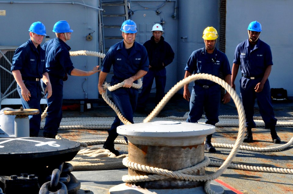 US Navy 110423-N-7293M-137 Boatswain's Mate Seaman Michael Mello flips a mooring line off the port capstan on the forecastle of USS Ponce (LPD 15)