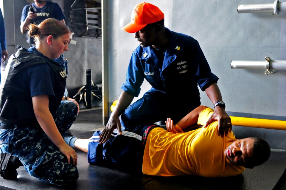 US Navy 110425-N-RC734-044 Boatswain's Mate 1st Class Michael Chatman, right, a member of the Force Protection Training Team, trains Ship's Service