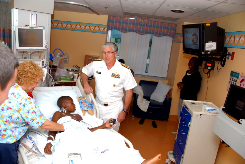 US Navy 110428-N-PS473-024 Vice Adm. Daniel P. Holloway visits with a child at the Joe DiMaggio Children's Hospital in Hollywood, Fla. during Fleet