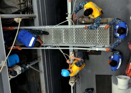 US Navy 110426-N-NL541-292 Sailors assigned to the guided-missile frigates USS Thach (FFG 43) and USS Boone (FFG 28) set up a brow between the two