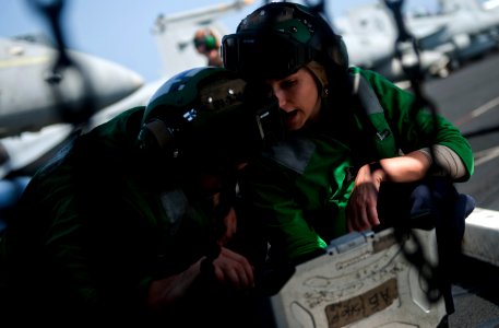 US Navy 110429-N-2055M-042 Aviation Electrician's Mate 2nd Class Amanda Mondino ives instructions to Aviation Electrician's Mate Airman Christopher