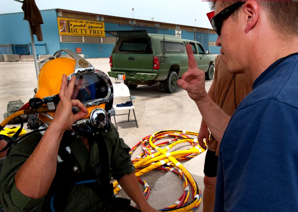 US Navy 110426-N-OT964-183 Navy Diver 2nd Class Troy Crowder, left, gives an okay to Navy Diver 1st Class Jeffrey Whisnant after completing a pre-d