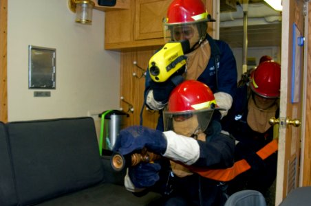 US Navy 110502-N-SP676-033 Information Systems Technician 2nd Class Herman Bennett leads a fire team during a damage control drill