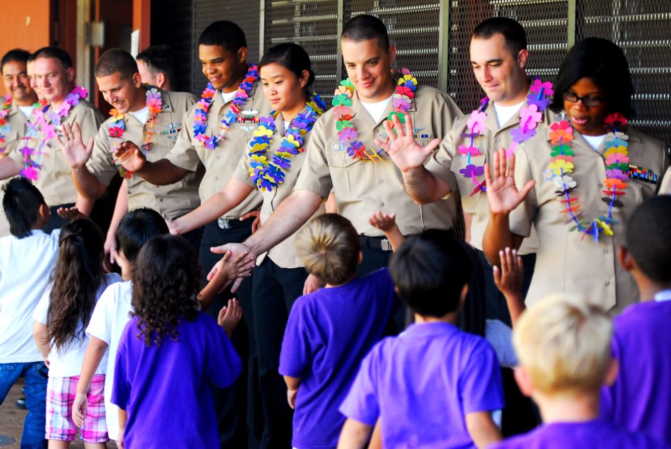 US Navy 110426-N-WP746-257 Students at Pearl City Elementary School give Sailors assigned to Commander, Navy Region Hawaii high-fives for the volun