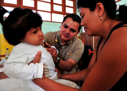 US Navy 110503-N-QD416-073 Mexican navy Lt. Jesus Espinoza examines a patient at a medical clinic during Continuing Promise 2011 photo