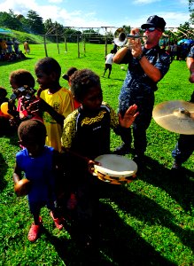 US Navy 110430-N-KB563-381 Musician 1st Class John Wheeler, a member of the Pacific Partnership 2011 band, plays trumpet during a community service