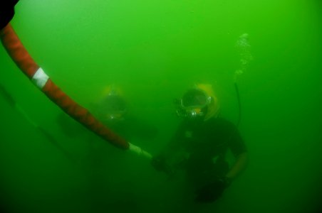 US Navy 110426-N-OT964-329 Navy Diver 1st Class Dean Bates, right, and Navy Diver 2nd Class Troy Crowder conduct a surface-supplied training dive