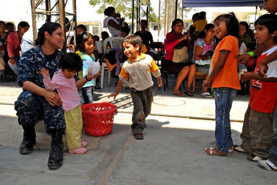 US Navy 110504-N-EP471-592 Lt. Sheila Almendras-Flaherty plays with a group of Peruvian children during a community service event for Continuing P