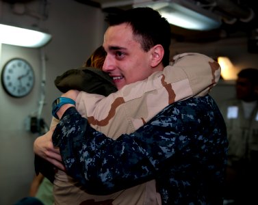 US Navy 110428-N-8040H-007 Engineman 2nd Class Timothy Baker and his mother, Logistics Specialist 2nd Class Stella Baker embrace in the air transfe