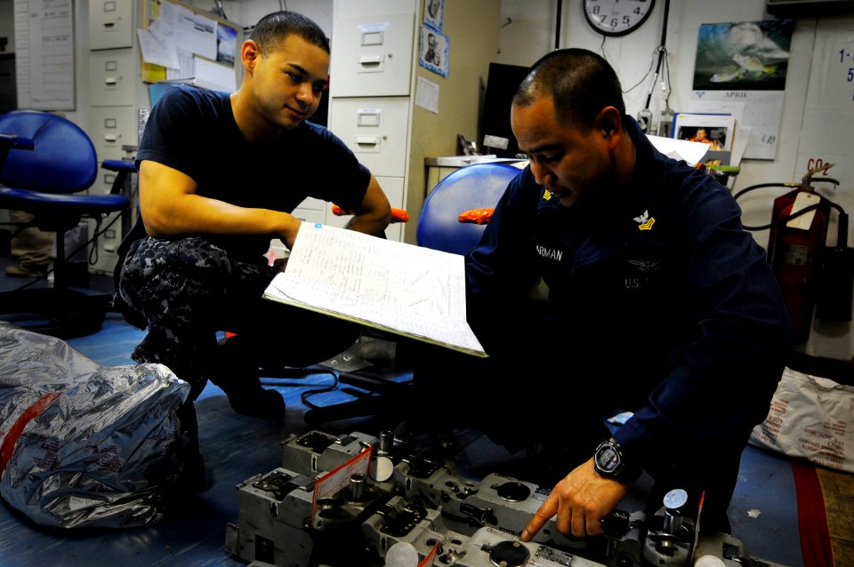 US Navy 110430-N-7488A-057 Aviation Ordnanceman 1st Class Silvino Carman trains Aviation Ordnanceman Airman Michael Willars to check for damage on