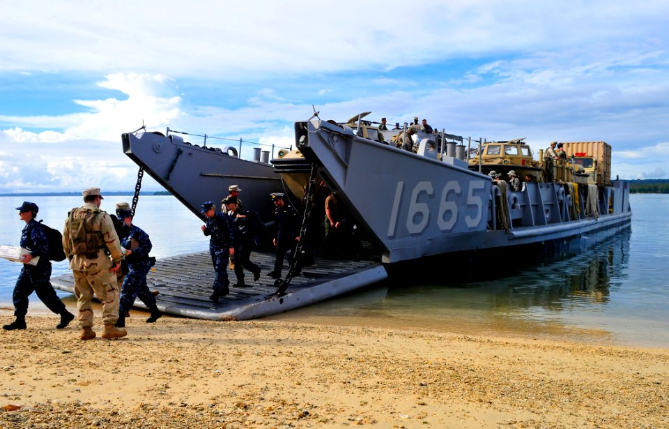 US Navy 110428-N-KB563-131 Sailors exit Landing Craft Utility (LCU) 1665 on the beach in Espiritu Santo during Pacific Partnership 2011