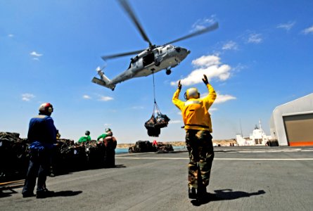 US Navy 110430-N-EP471-239 Sailors assigned to Helicopter Sea Combat Squadron (HSC) 26 and Military Sealift Command civil service mariners guide an