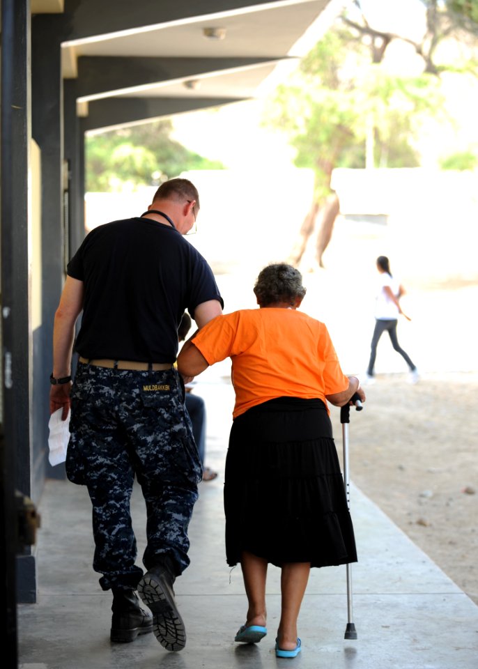 US Navy 110503-N-NY820-189 Lt. Cmdr. Rolf Muldbakken walks a patient to an examination room during Continuing Promise 2011