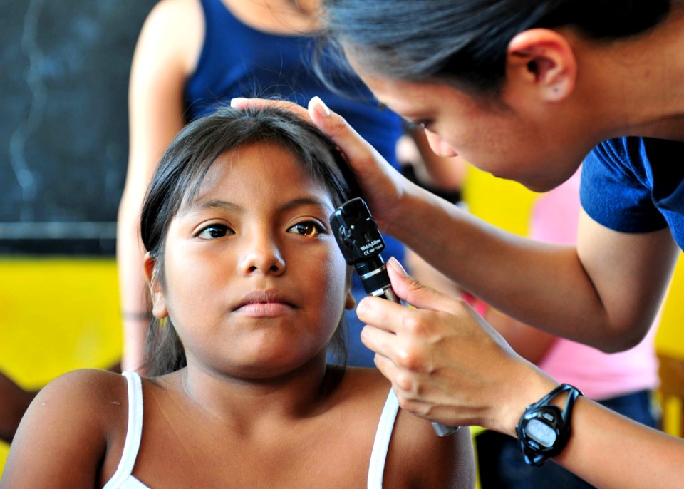 US Navy 110503-N-QD416-154 Lt. Patricia Salazar examines a patient's eyes at a Continuing Promise 2011 medical clinic