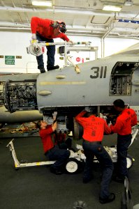 US Navy 110430-N-1004S-271 Sailors install an M61A1 20 mm gun onto an F-A-18C Hornet in the hangar bay aboard USS Ronald Reagan (CVN 76)