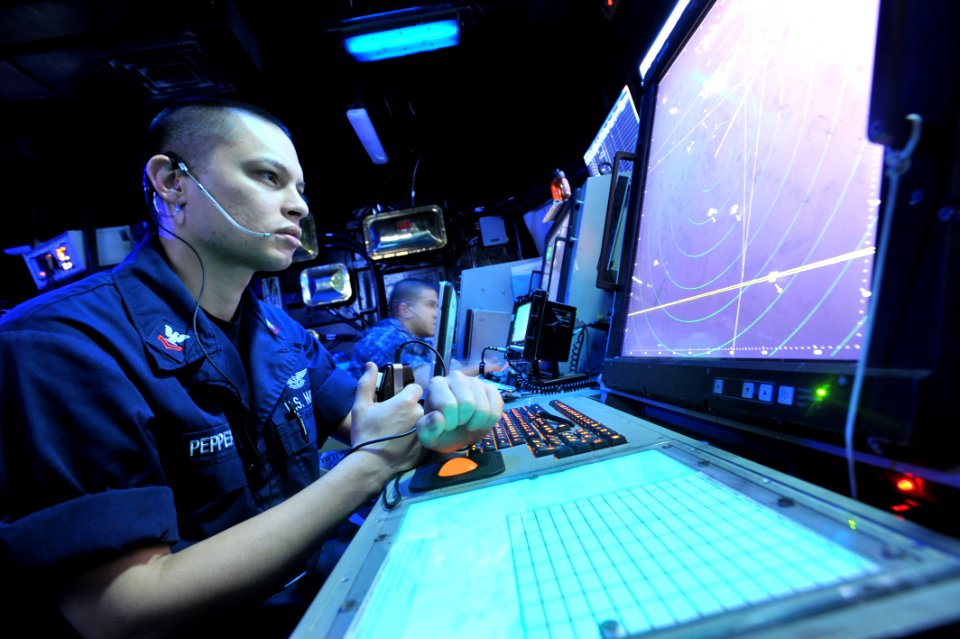 US Navy 110503-N-0569K-007 Air Traffic Controller 2nd Class Andrew Pepper communicates with pilots in the Carrier Air Traffic Control Center aboard