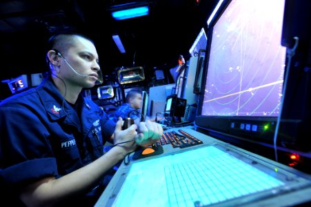 US Navy 110503-N-0569K-007 Air Traffic Controller 2nd Class Andrew Pepper communicates with pilots in the Carrier Air Traffic Control Center aboard