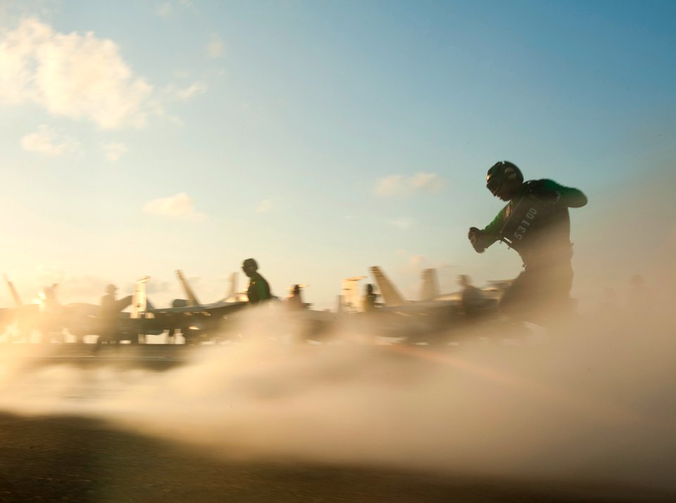 US Navy 110504-N-DR144-585 Sailors run to prepare the catapults for the next launch aboard USS Carl Vinson (CVN 70)