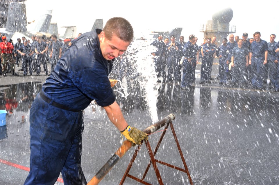 US Navy 110506-N-0569K-013 A Sailor attempts to mend a simulated pipe burst during Damage Control (DC) Olympics aboard USS Enterprise (CVN 65)