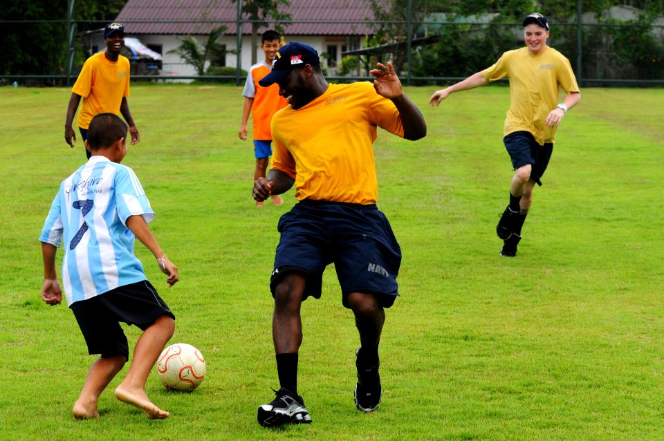 US Navy 110504-N-IC111-759 Sailors and Marines assigned to the aircraft carrier USS Ronald Reagan (CVN 76) play soccer with children from the Youth