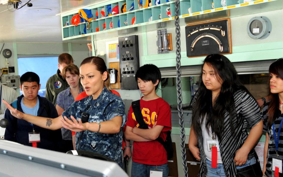 US Navy 110428-N-UN340-002 Hospital Corpsman 2nd Class Silvia Torres explains navigation equipment on the bridge aboard USNS Mercy (T-AH 19)