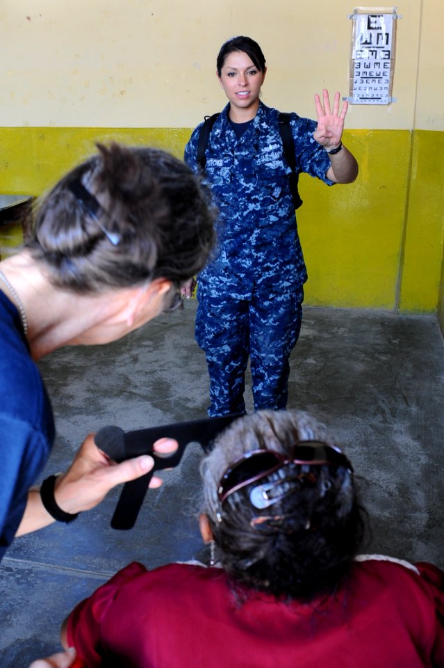 US Navy 110501-F-CF975-136 Hospital Corpsman 2nd Class Amanda Fletcher, from Valencia, Calif., conducts an eye exam during a medical clinic at Sagr