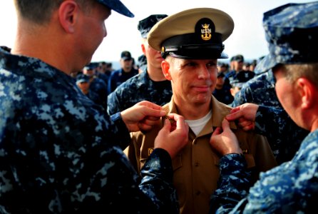 US Navy 110506-N-ZS026-007 Newly-selected Master Chief Personnel Specialist Edward Aksztulewicz receives his master chief petty officer collar devi