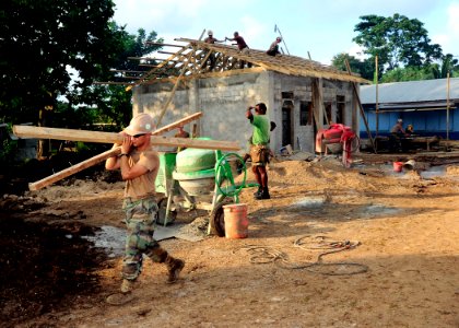 US Navy 110504-F-HS649-012 Seabees assigned to Naval Mobile Construction Battalion (NMCB) 133 and Vanuatu citizens work at an engineering civil act photo