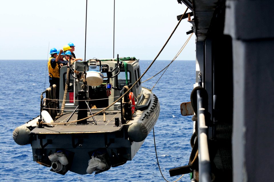 US Navy 110505-N-RC734-060 A rigid-hull inflatable boat and its crew are lifted aboard USS Comstock (LSD 45)