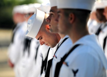 US Navy 110506-N-GS507-135 Cryptologic Technician (Network) 2nd Class Gianni Laban performs a last-minute check of his uniform before a command ins