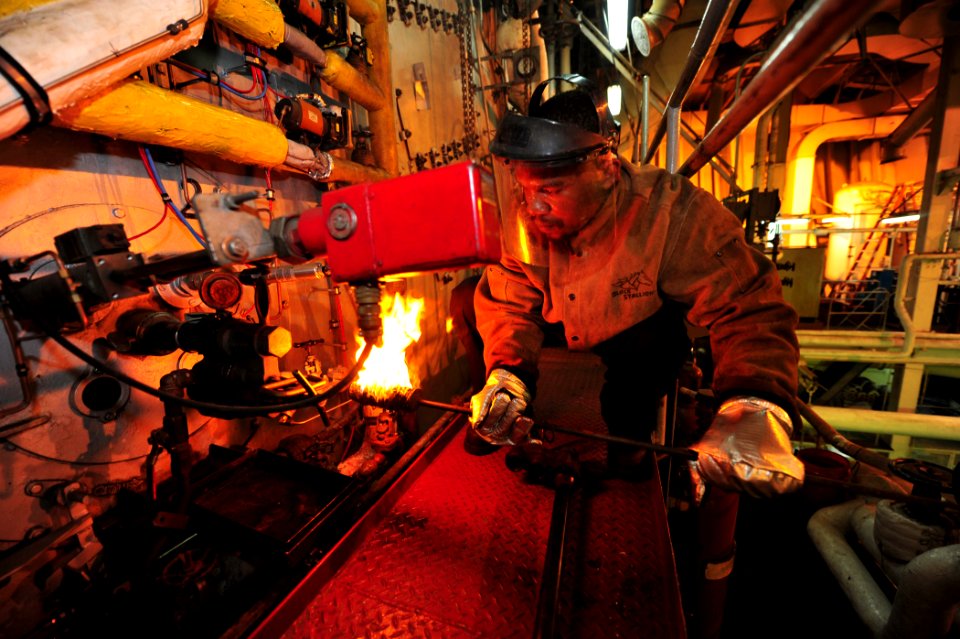 US Navy 110504-F-ET173-055 Engine Utility Willie Grant lights off a burner aboard the Military Sealift Command hospital ship USNS Comfort (T-AH 20)