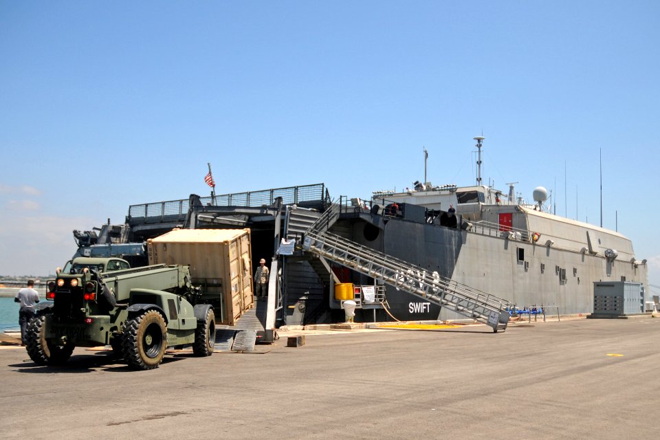 US Navy 110503-N-AW868-125 Seabees load a storage container onto High Speed Vessel Swift (HSV 2) while moored at Naval Station Rota, Spain