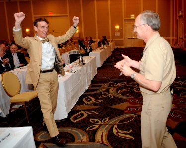 US Navy 110505-N-PO203-200 Bill Nye, left, gets excited as the Chief of Naval Research Rear. Adm. Nevin Carr presents him with a powered by Naval R