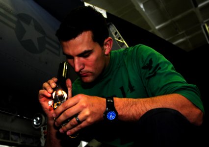 US Navy 110509-N-OI955-091 Aviation Electronics Technician 2nd Class Justin Sexton rewires a master arm control panel from an F-A-18C Hornet