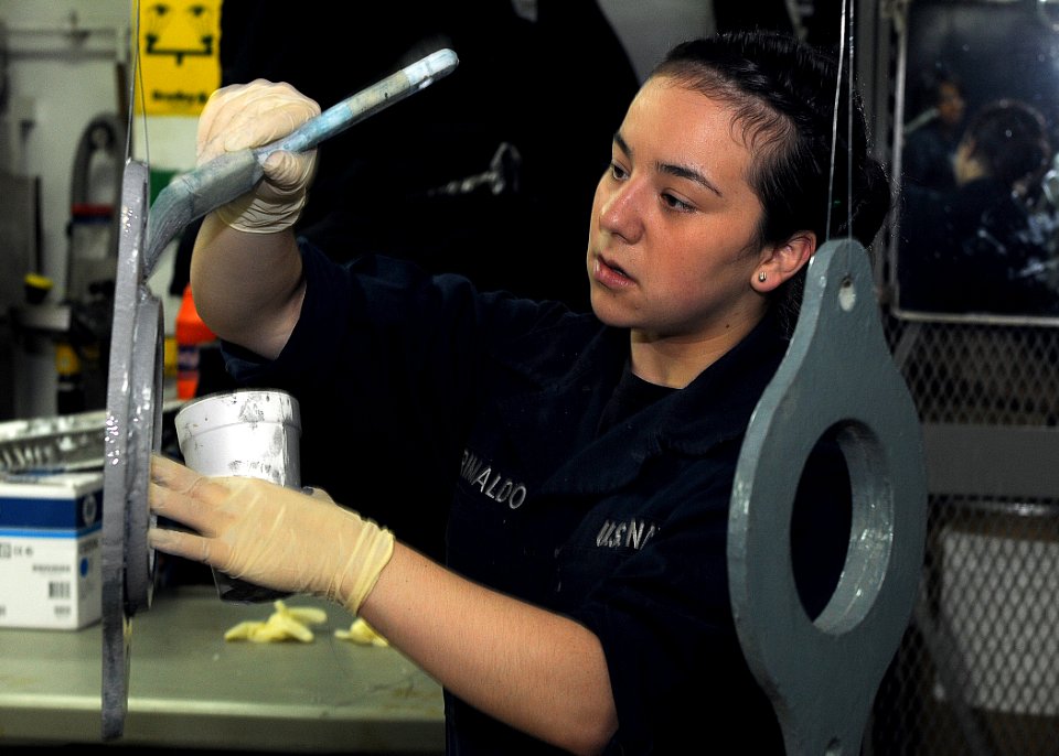 US Navy 110506-N-2908M-008 Aviation Maintenance Administration Airman Justine Grimaldo paints shock rings in preparation for installation on the ca
