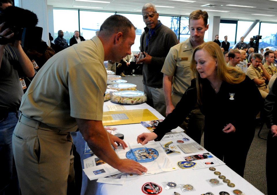 US Navy 110506-N-KK330-199 Maureen Murphy, mother of Lt. Michael P. Murphy (SEAL) and ship's sponsor, lays a coin that is to be welded into the mas