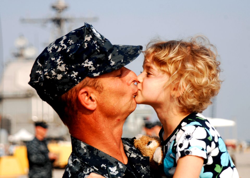 US Navy 110510-N-DU438-039 Fire Controlman 2nd Class Geoffrey J. Bourget, assigned to the guided-missile cruiser USS Gettysburg (CG 64), kisses his
