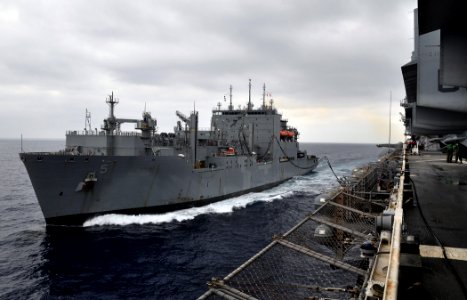 US Navy 110505-N-7508R-001 The multipurpose amphibious assault ship USS Bataan (LHD 5), right, conducts an underway replenishment with the Military photo
