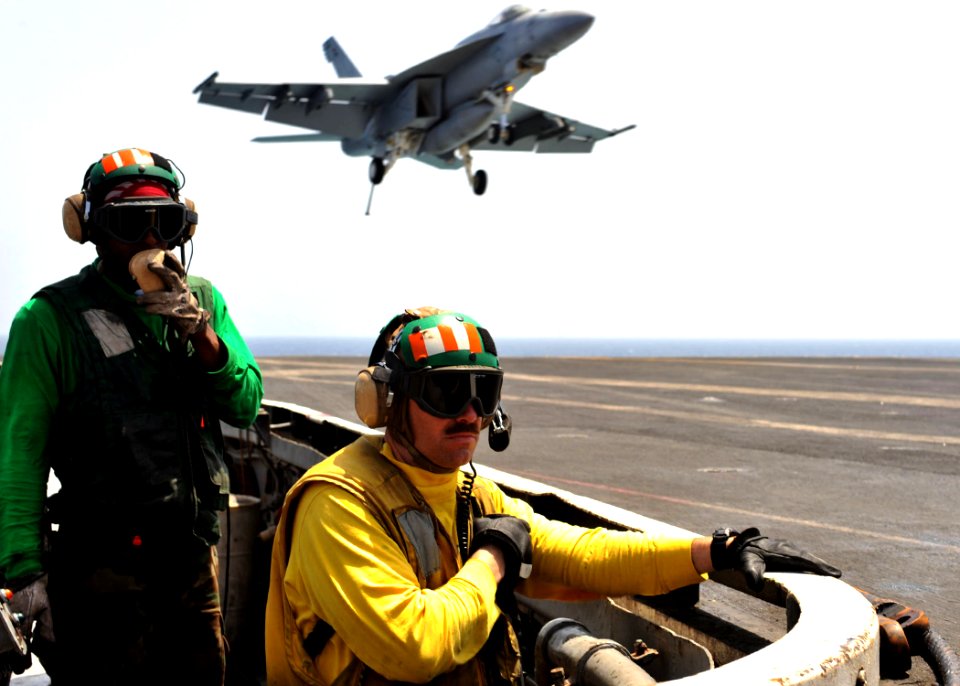 US Navy 110509-N-0569K-149 Aviation Boatswain's Mate (Equipment) 3rd Class Vincheza T. Carter, left, and Lt. John L. Alums ensure a safe landing fo