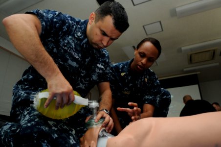 US Navy 110506-N-IO627-059 Gunner's Mate 1st Class John Linke practices using a resuscitation bag on a dummy during a cardiopulmonary resuscitation