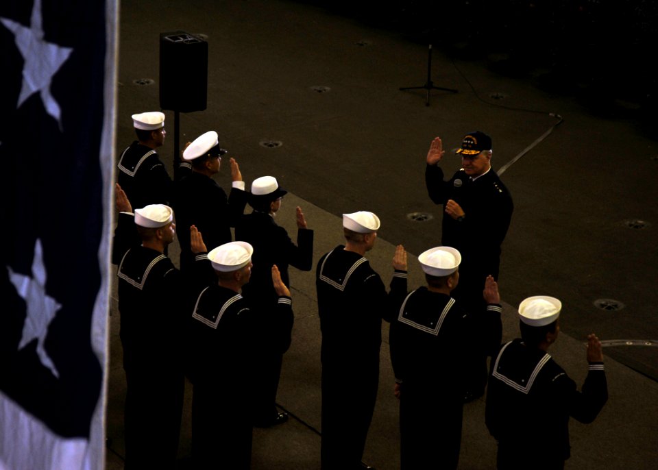 US Navy 110510-N-YB753-024 Chief of Naval Operations (CNO) Adm. Gary Roughead administers the oath of enlistment to ten Sailors aboard USS Abraham