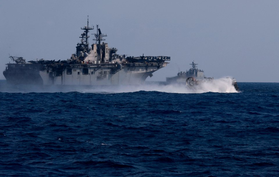 US Navy 110507-N-QP268-135 A landing craft air cushion passes along the starboard side of USS Bataan (LHD 5) as USS Whidbey Island (LSD 41) transit