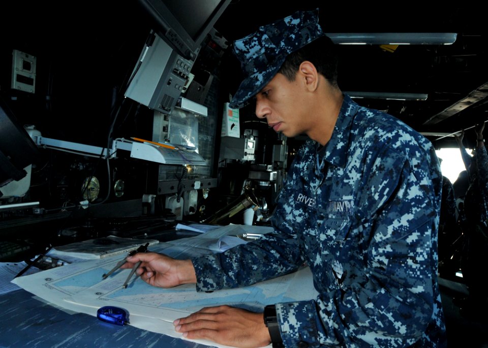 US Navy 110509-N-NL541-086 Quartermaster Seaman Ephrain Rivera, assigned to the guided-missile frigate USS Thach (FFG 43), performs nautical chart