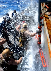 US Navy 110505-N-OS574-146 Marines climb into a rigid-hull inflatable boat during a visit, board, search and seizure, hook and pull exercise
