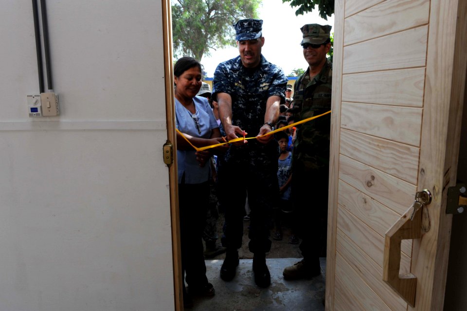 US Navy 110508-F-ET173-575 The Cruz Maria Minan Quezada school principal, left, Commodore Brian Nickerson and Ensign Tres Moreno cut the ribbon on