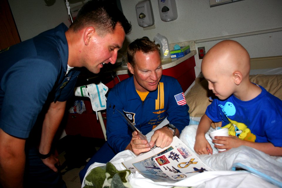US Navy 110506-N-ZL585-030 Lt. Jason Smith, center, and Hospital Corpsman 1st Class John Mocek visit with young patients at Children's Hospital New