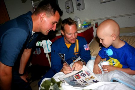 US Navy 110506-N-ZL585-030 Lt. Jason Smith, center, and Hospital Corpsman 1st Class John Mocek visit with young patients at Children's Hospital New