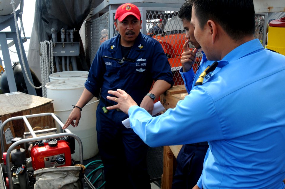 US Navy 110510-N-SP676-049 Hospital Corpsman 1st Class Benjamin Corrido listens as Malaysian navy Lt. Lim Kim Tat asks questions